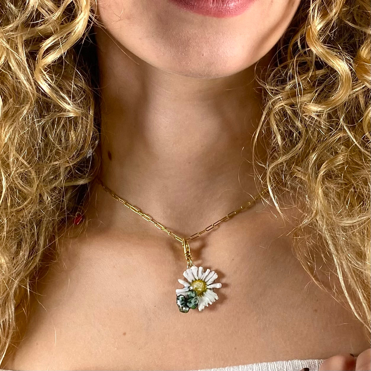 Charm portafortuna con un vero quadrifoglio e margherita, gancio in argento dorato.