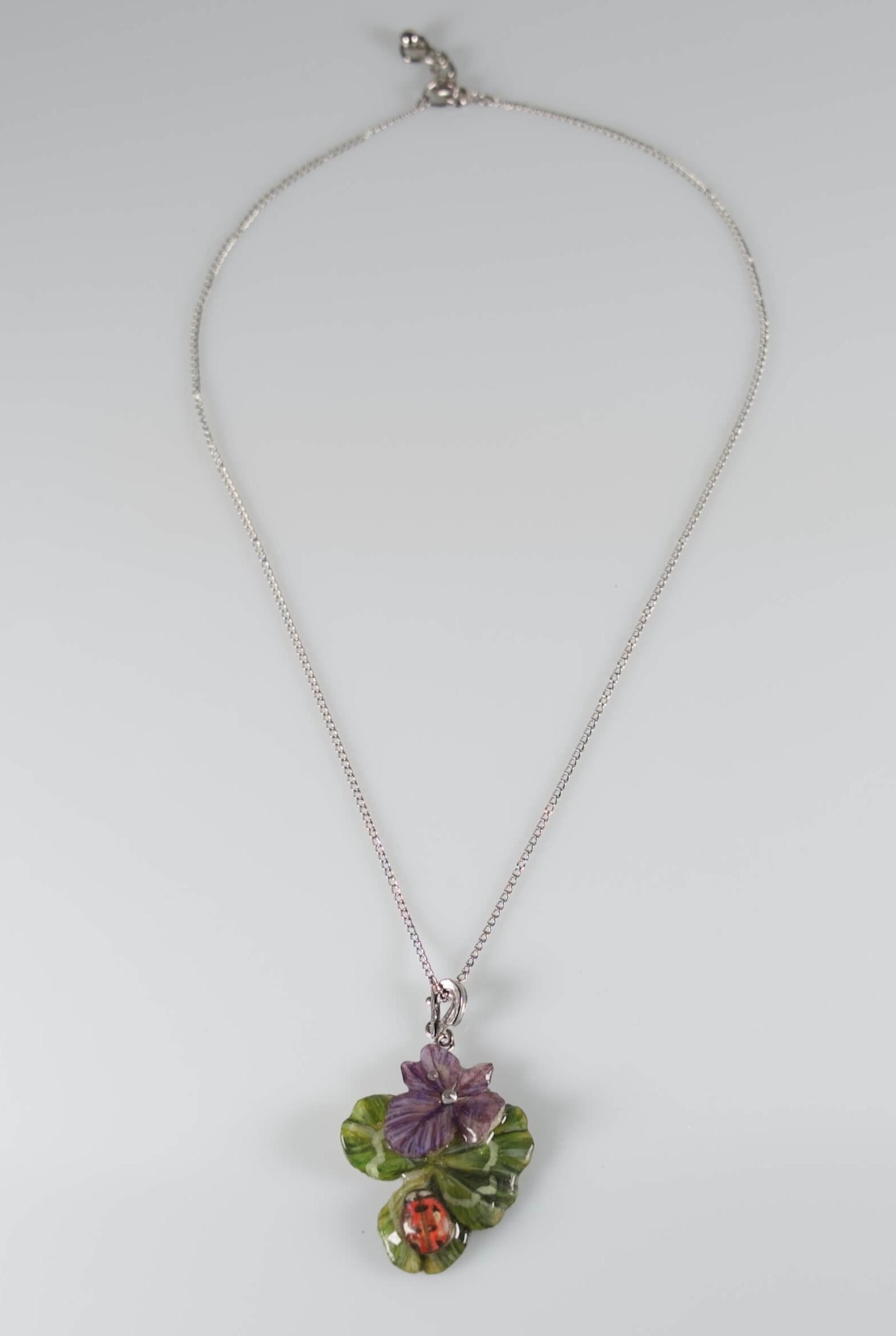 Collana con ciondolo con quadrifoglio e fiori