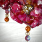 Parure con rose rosse e quadrifoglio